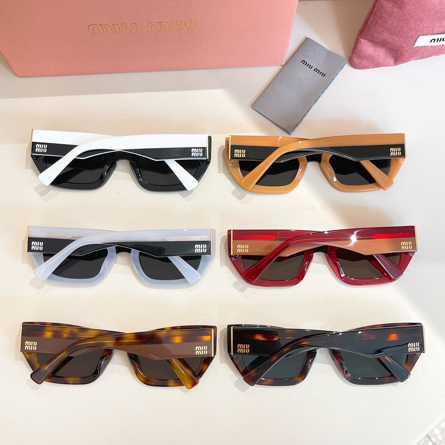 Set of six MiuMiu sunglasses with mixed frames and dark lenses.