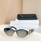 Cream cat-eye sunglasses with gold logo detail and light blue lenses.