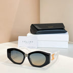 Black cat-eye sunglasses with gold logo detail and dark lenses.