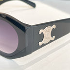 Black cat-eye sunglasses close-up with gold Celine logo on temple.