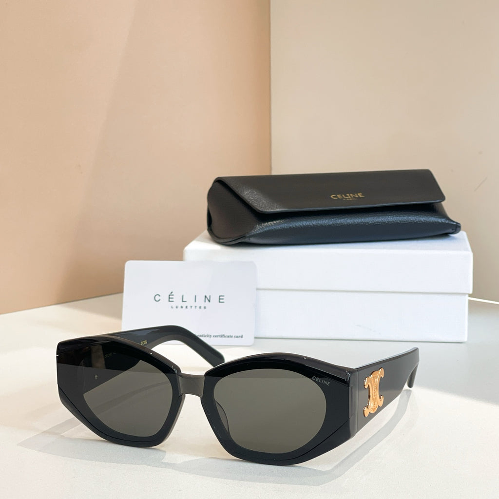 Black cat-eye sunglasses with gold logo detail and smoky gray lenses.