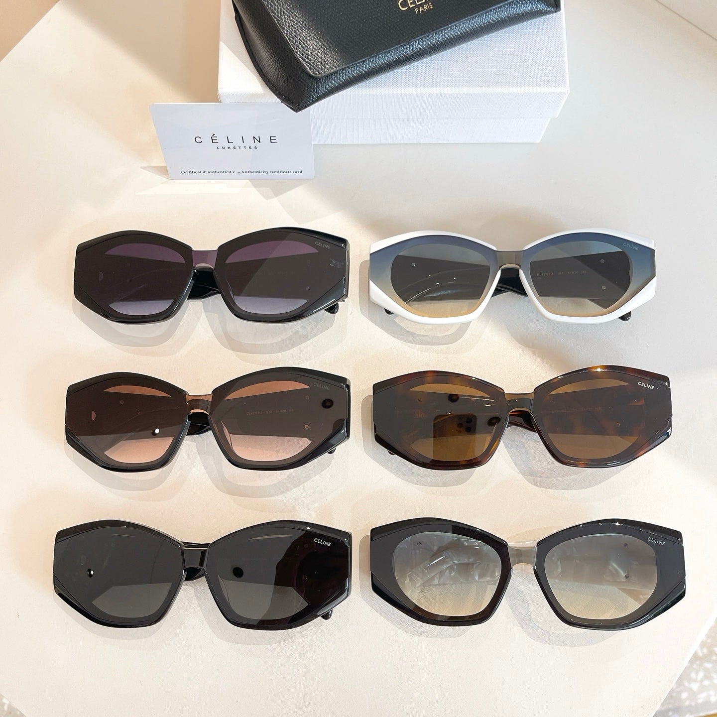 Assorted cat-eye sunglasses set with black, cream, and tortoiseshell frames.