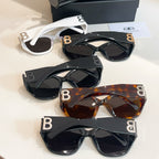 Assorted sunglasses with gold-tone "B" details and dark lenses in multiple frames