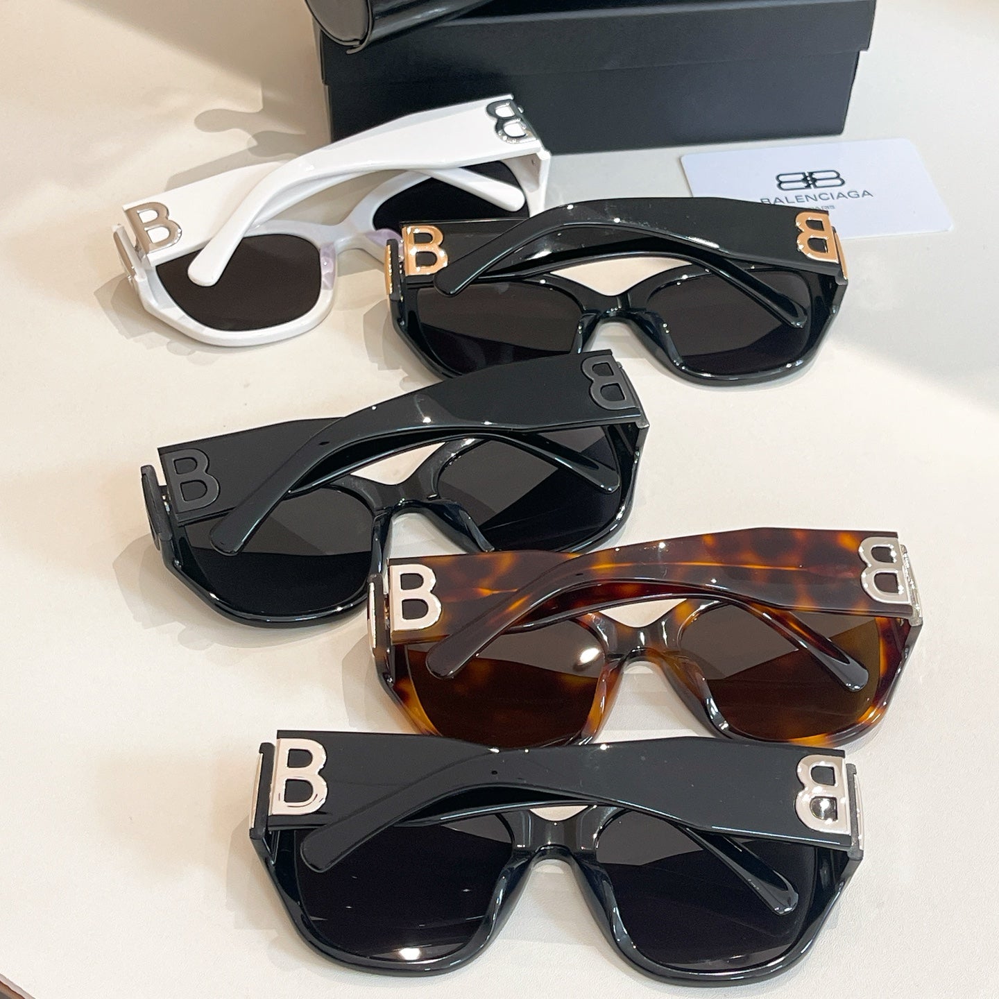 Assorted sunglasses with gold-tone "B" details and dark lenses in multiple frames