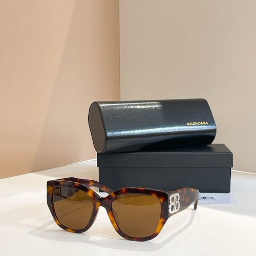 Tortoiseshell sunglasses with dark lenses and wide square frame