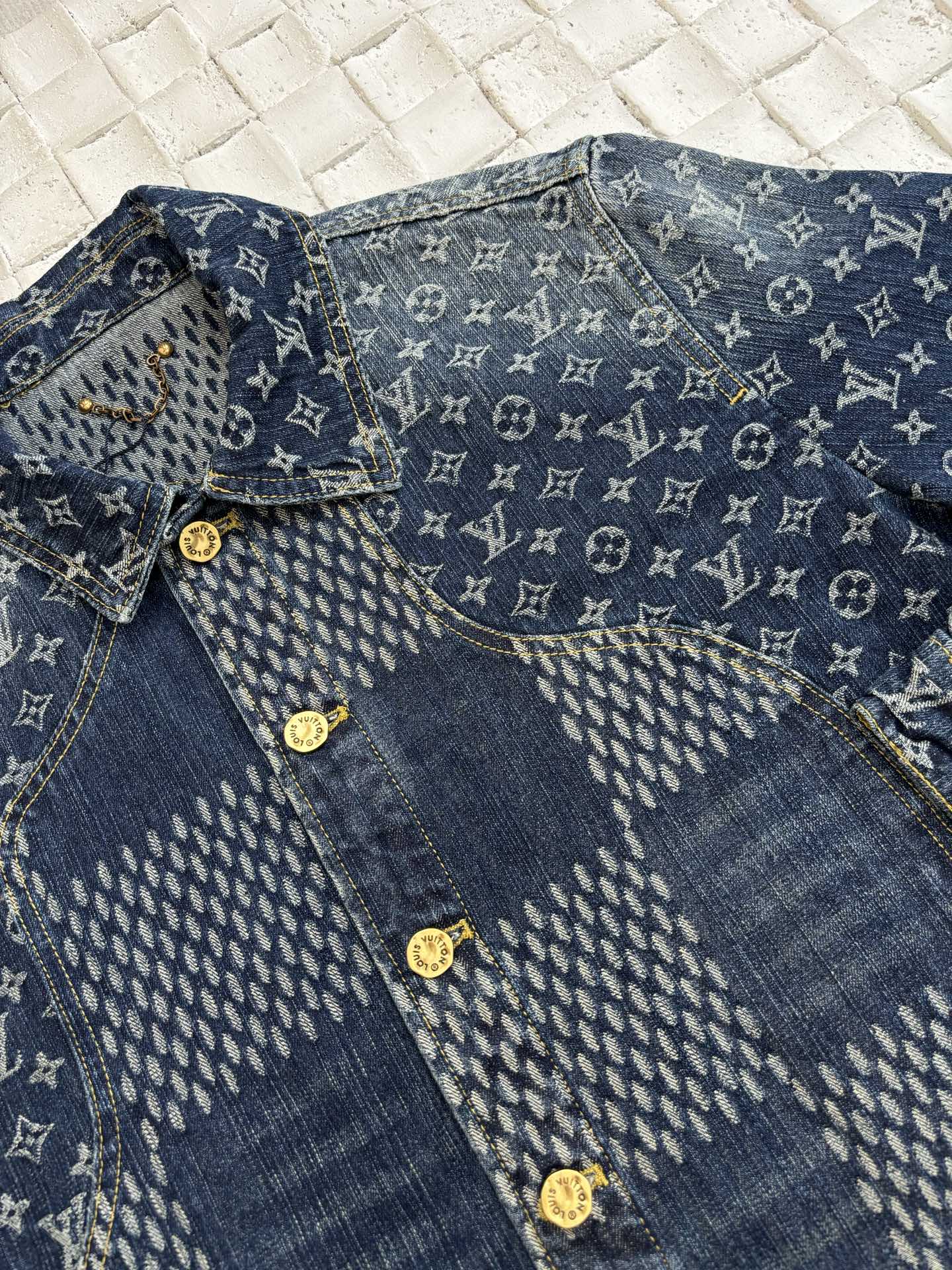 Louis Vuitton long-sleeve denim jacket close-up with blue monogram button placket