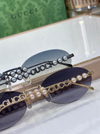 Round sunglasses close-up: pearl and rhinestone beaded chain with logo on lens arm