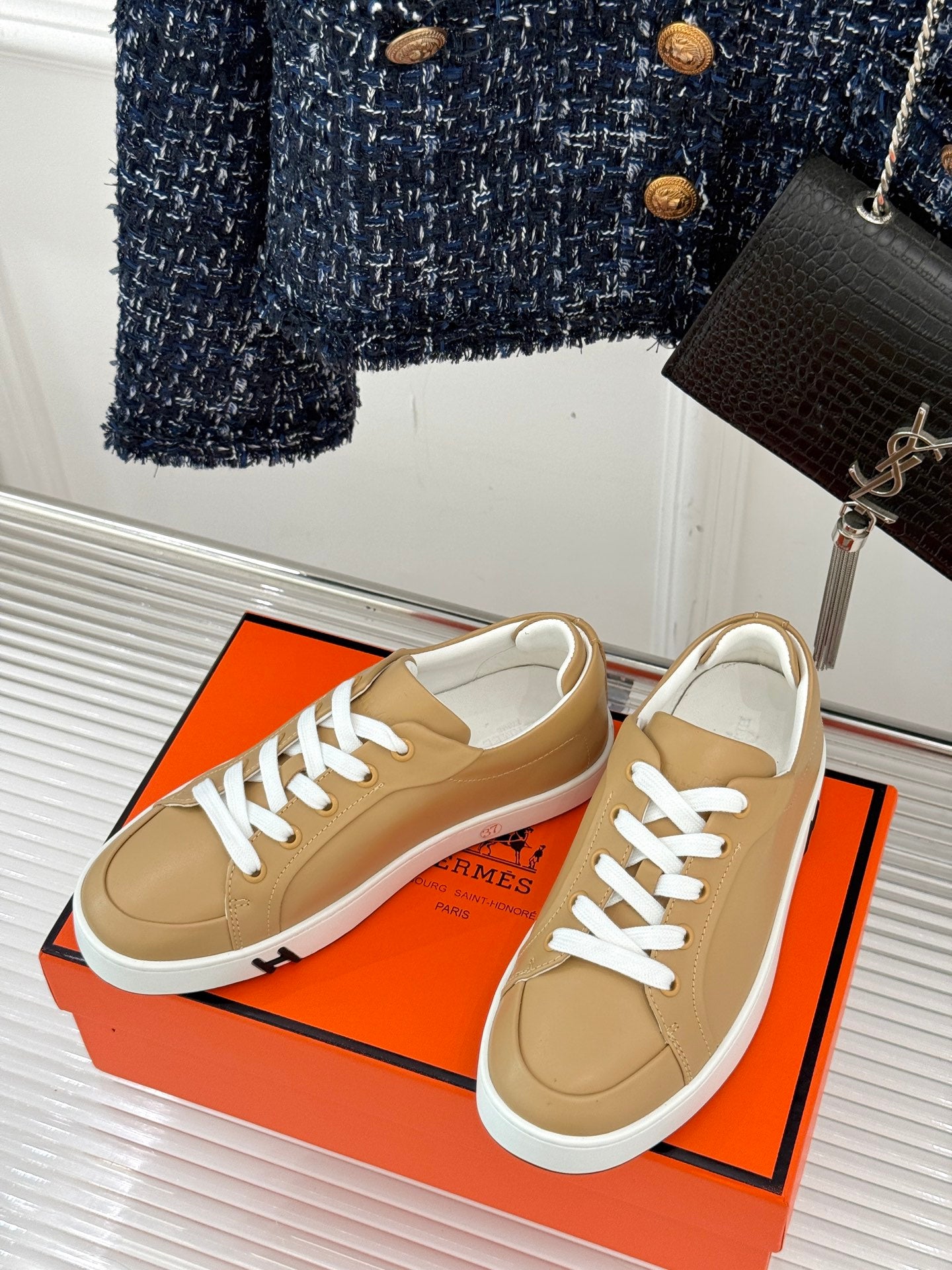 Pair of ladies' Hermes sneakers, tan uppers with white laces and white rubber sole