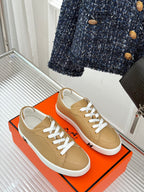 Ladies' Hermes sneakers, tan leather with white laces and low-profile rubber sole