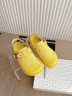 Yellow unisex loafers with cross-strap buckle and ridged sole