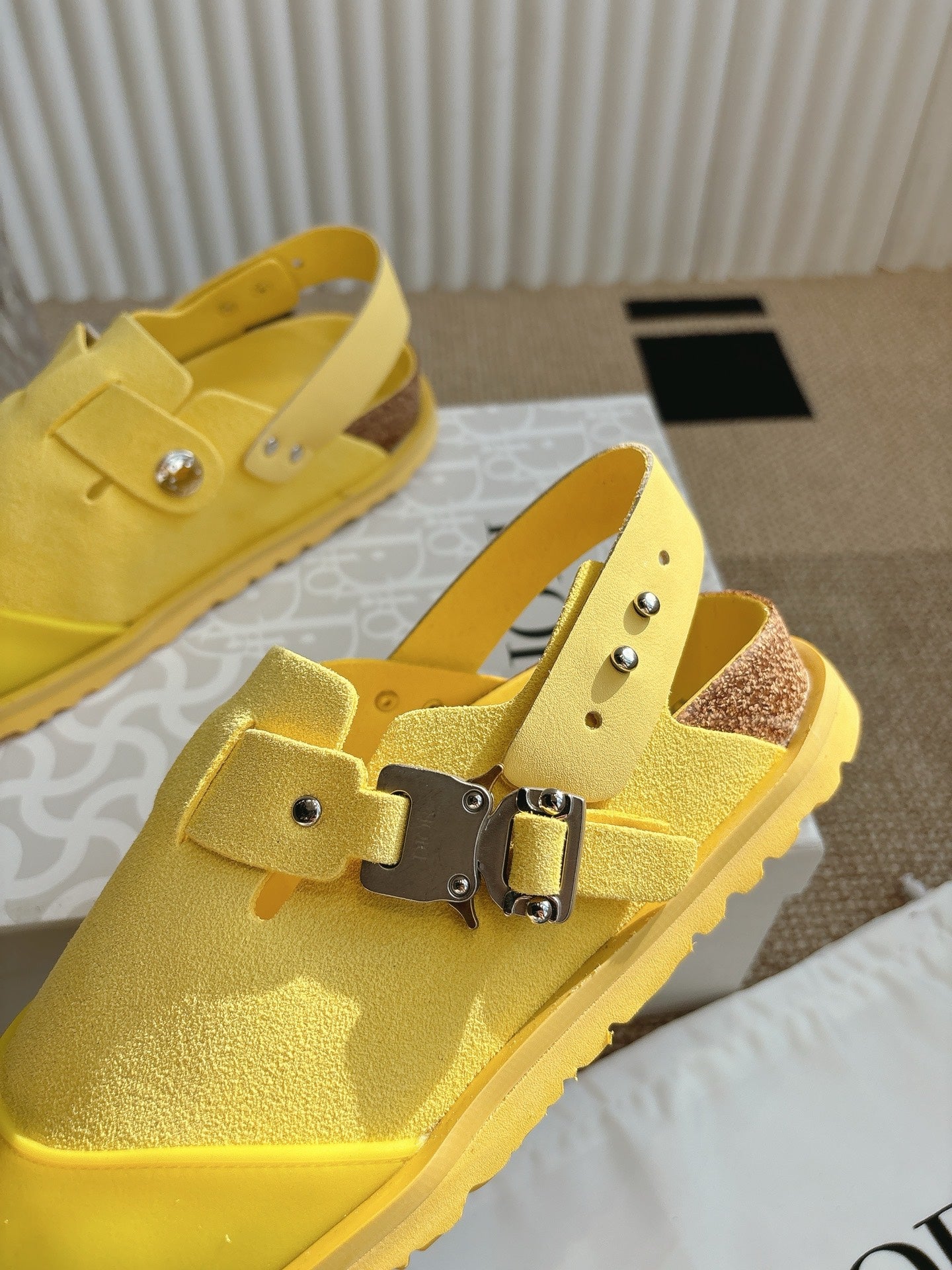 Yellow unisex shoes with double buckle strap, side and top views