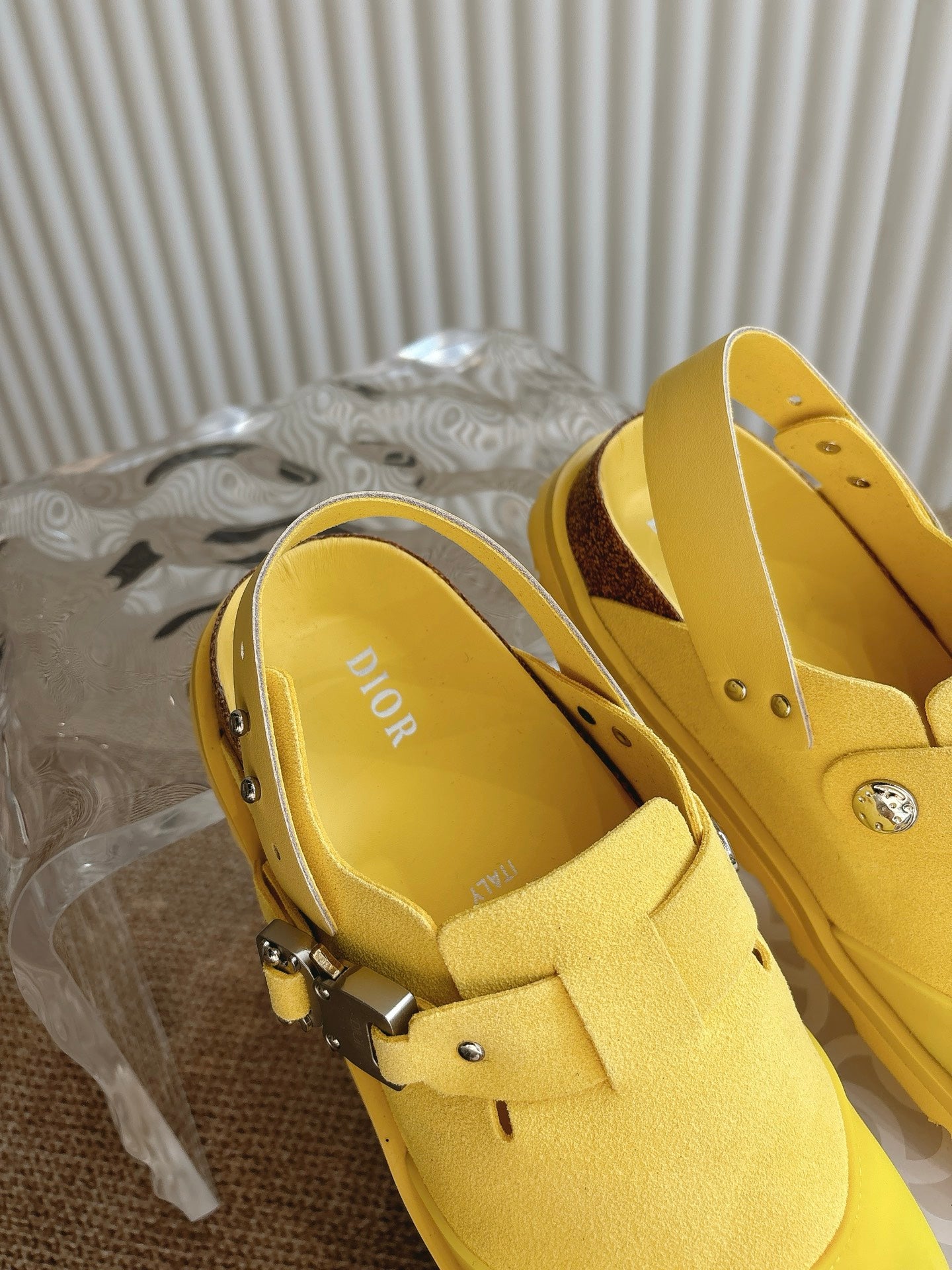 Yellow unisex shoes with Dior logo on insole, close side view