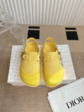 Yellow unisex slip-on shoes with buckle straps and textured sole