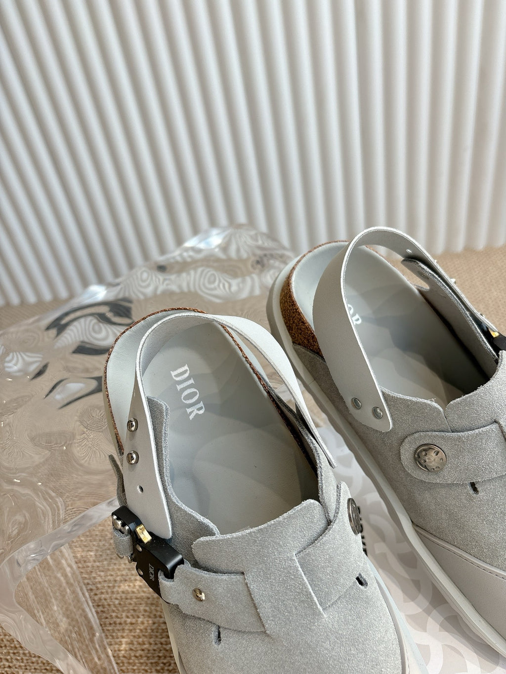 Light gray slip-on shoes showing interior lining and front strap