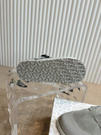 Light gray slip-on shoe outsole with textured tread pattern
