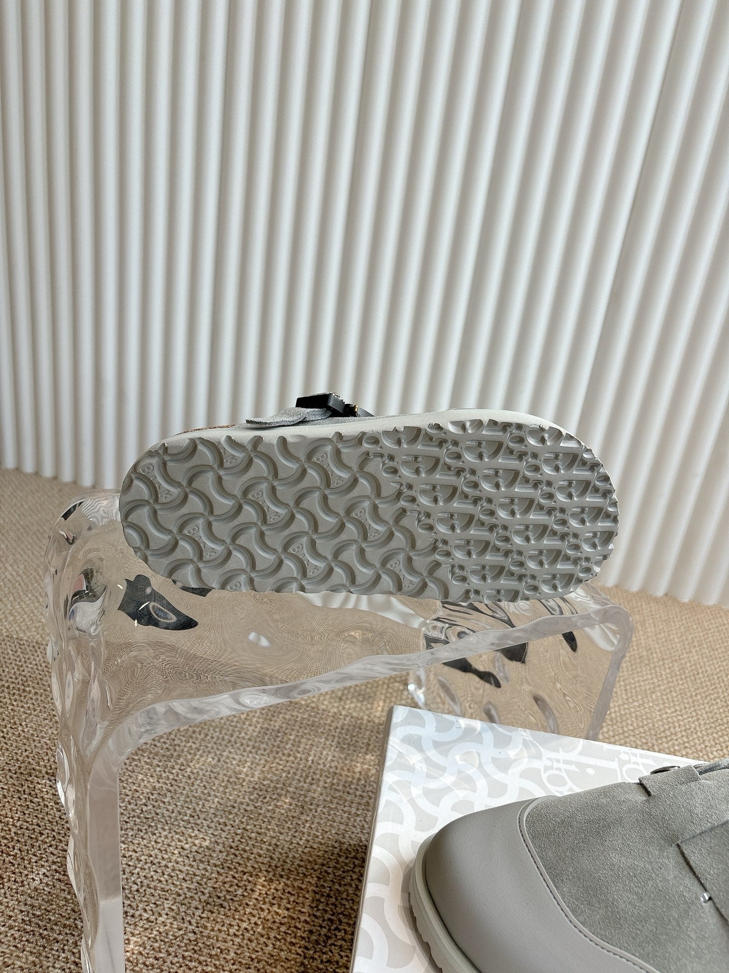 Light gray slip-on shoe outsole with textured tread pattern