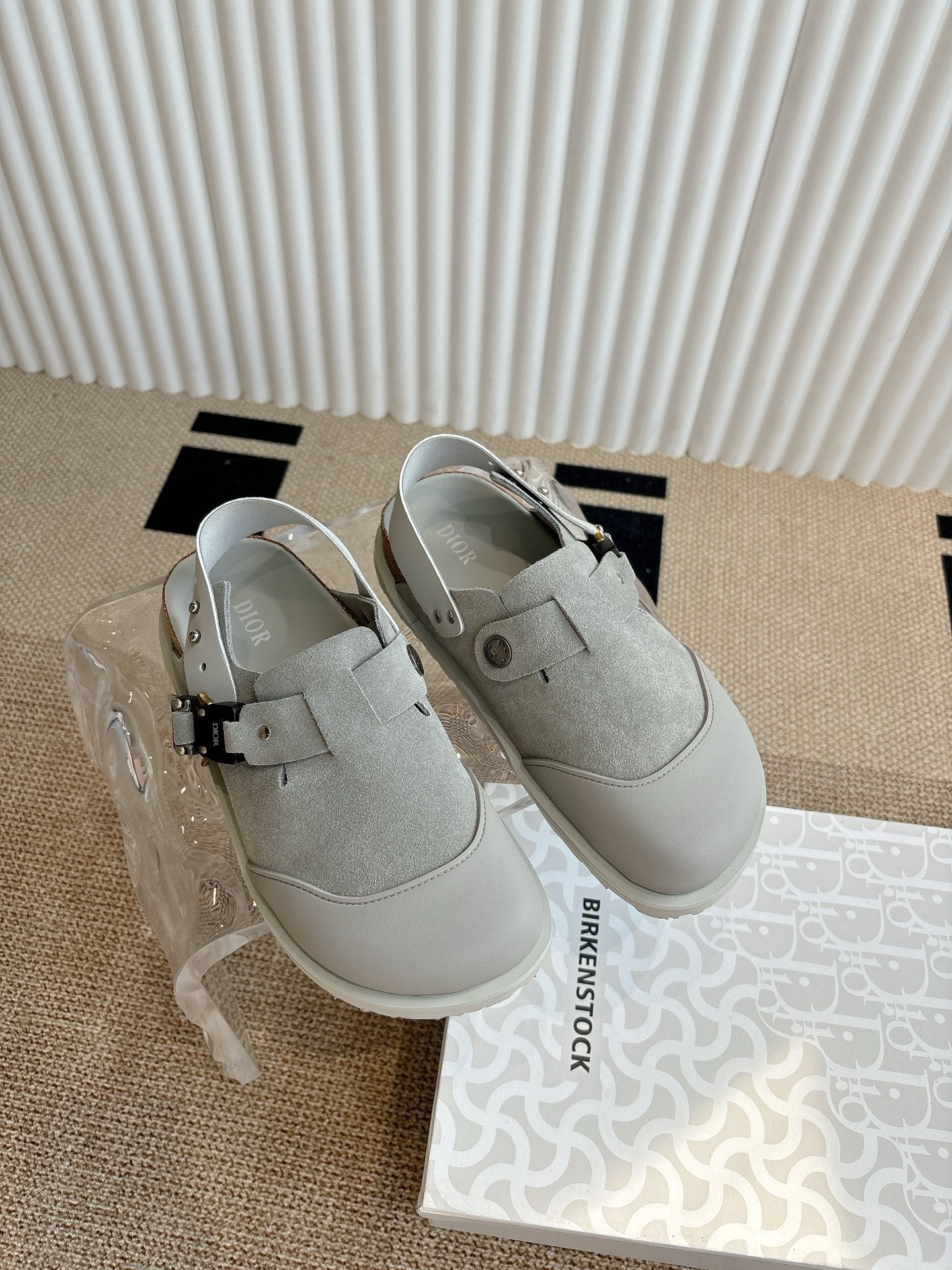 Light gray slip-on shoes with front strap and rounded toe