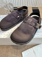 Close-up of unisex suede strap shoes with metal buckles, dark taupe