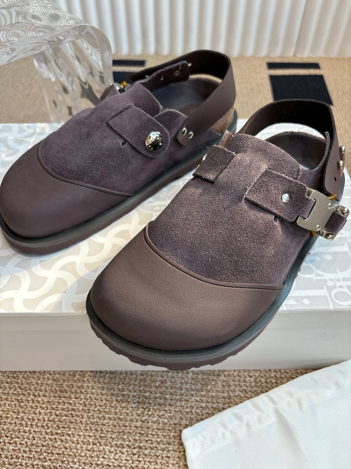 Close-up of unisex suede strap shoes with metal buckles, dark taupe