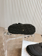Shoe outsole with textured dark rubber tread pattern