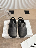 Black and dark gray slip-on shoes with felt uppers and adjustable buckle straps