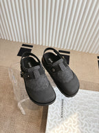 Black and dark gray slip-on shoes with felt toe and adjustable side buckle straps