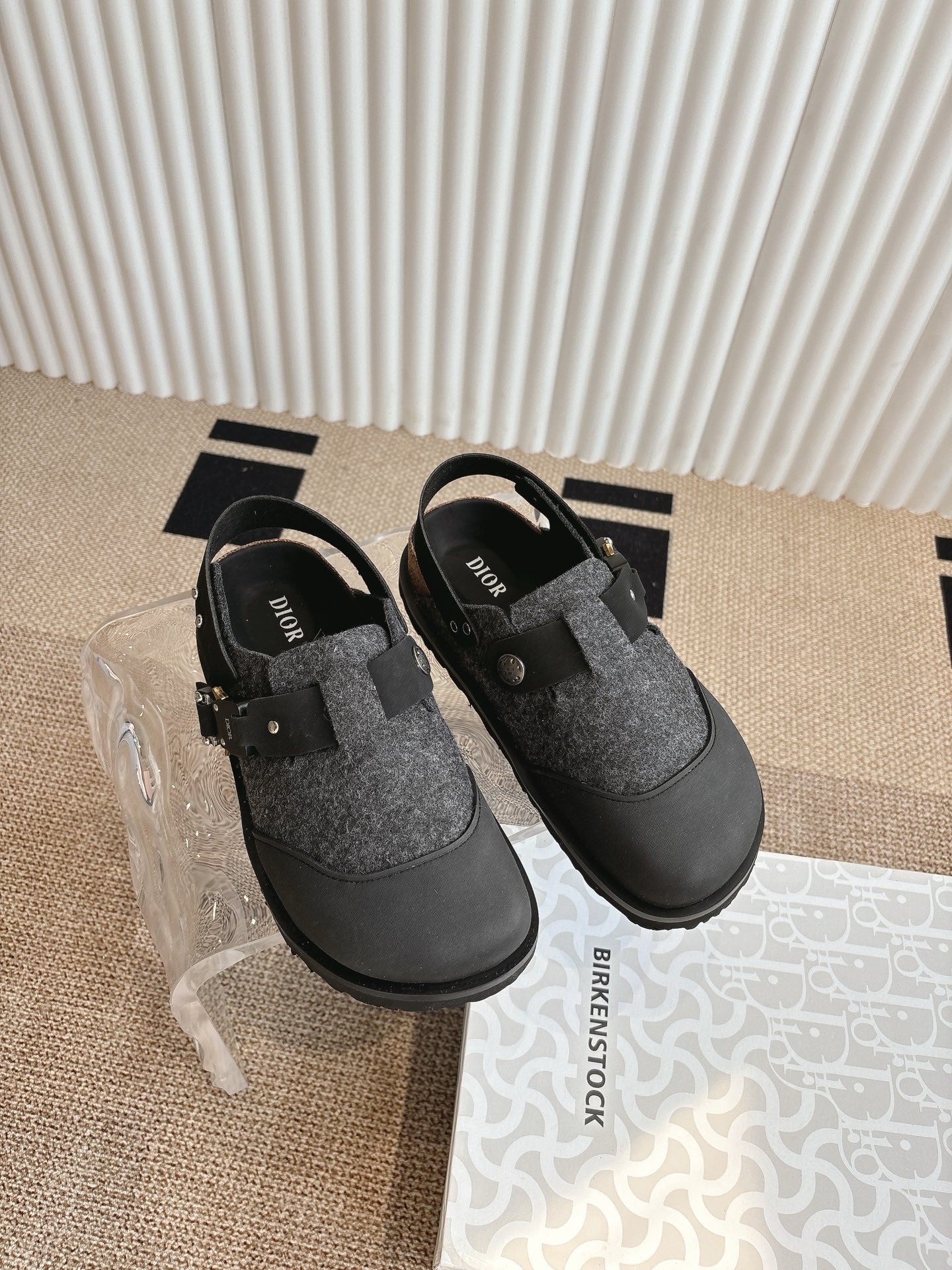 Black and dark gray slip-on shoes with felt toe and adjustable side buckle straps