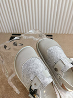 Dior unisex shoes with white straps, gray glitter vamp, and gold-tone stud hardware