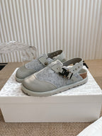 Dior unisex low-top shoes with gray textured uppers, white straps, and metal buckles