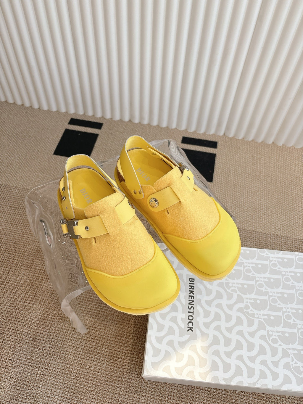 Dior unisex yellow slip-on shoes, angled pair with buckle strap