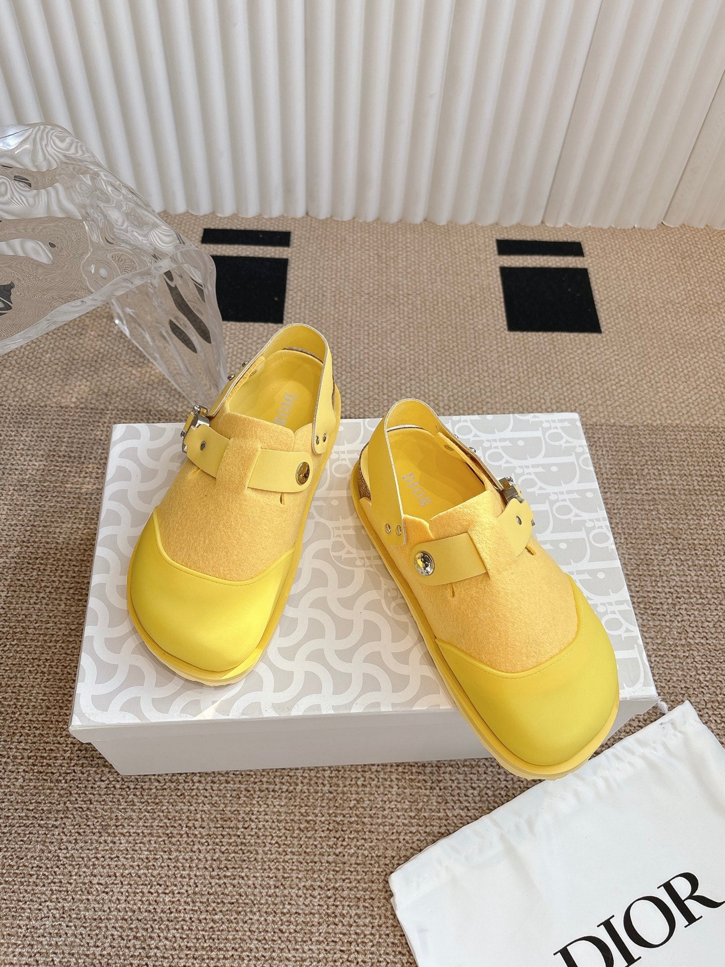 Dior unisex yellow slip-on shoes on box, side view with buckle strap