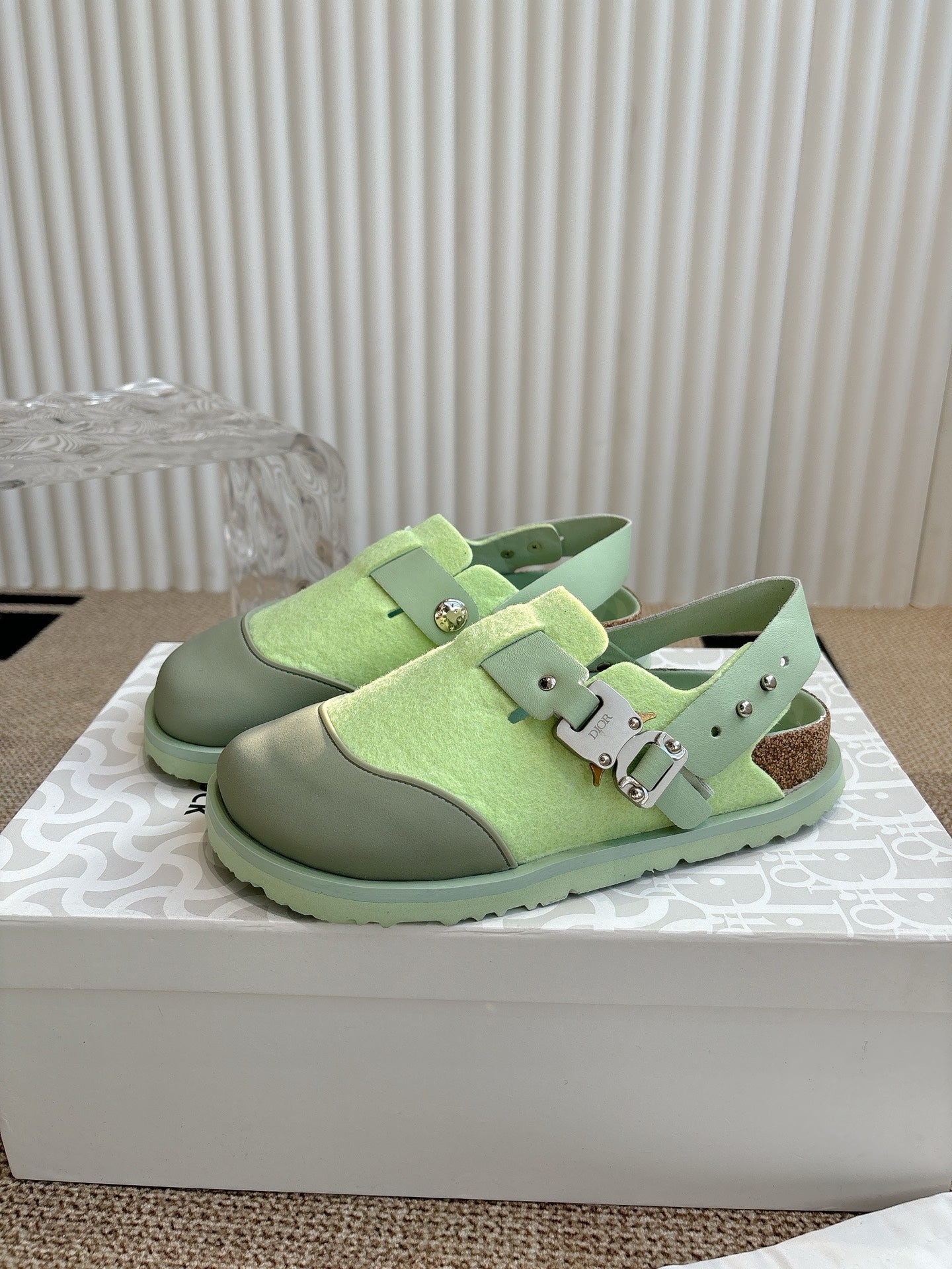 Unisex green sneakers with two-buckle strap, metal eyelets, and textured sole