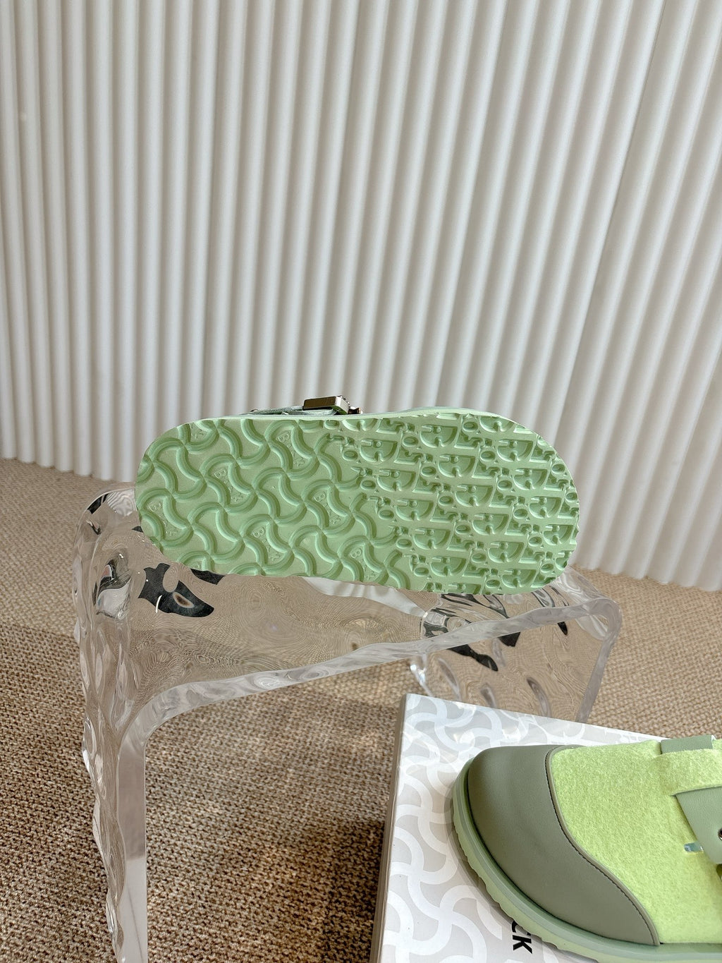 Unisex green sneaker outsole with textured tread, side profile under cover