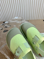 Unisex green sneakers with double straps and metal studs, top angle view