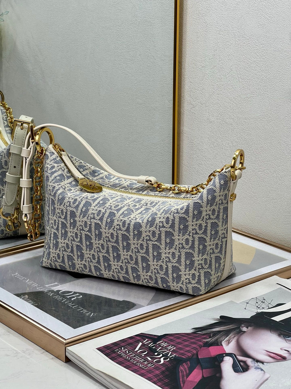 Medium shoulder bag in blue-and-white monogram canvas, gold chain strap with white handles.