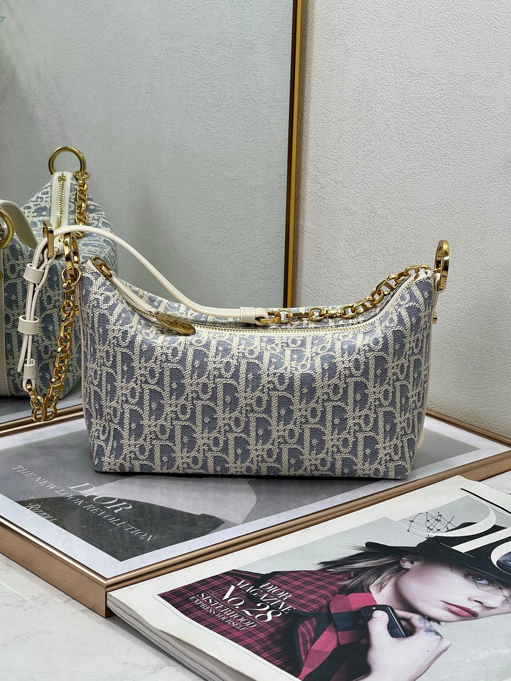 Dior monogram hobo bag in blue and white with top handles and chain shoulder strap