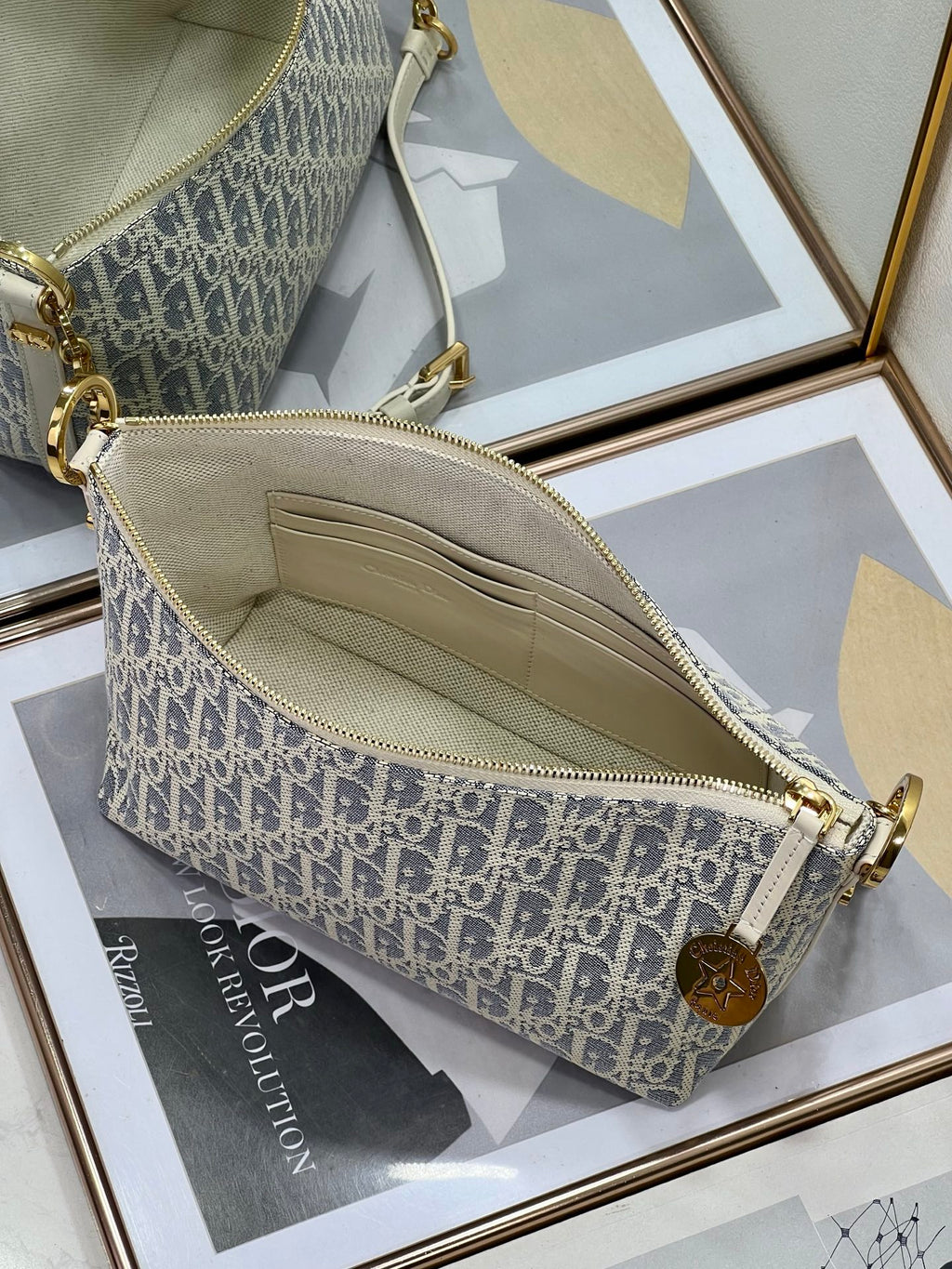 Dior monogram crossbody bag interior with zip and fabric lining, blue and white