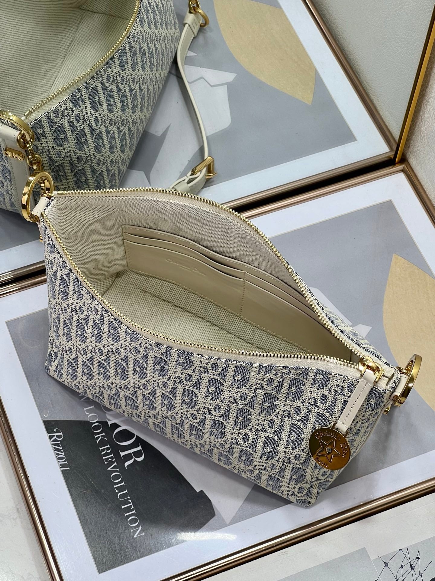 Dior monogram crossbody bag interior with zip and fabric lining, blue and white