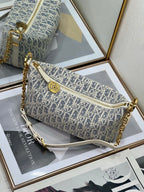 Dior monogram crossbody bag with chain strap, zip top, and star charm, blue