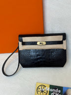 Hermes croc-embossed flap bag with gold turn-lock clasp and shoulder strap.