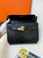Hermes bag in black croc-embossed leather with gold clasp and front flap