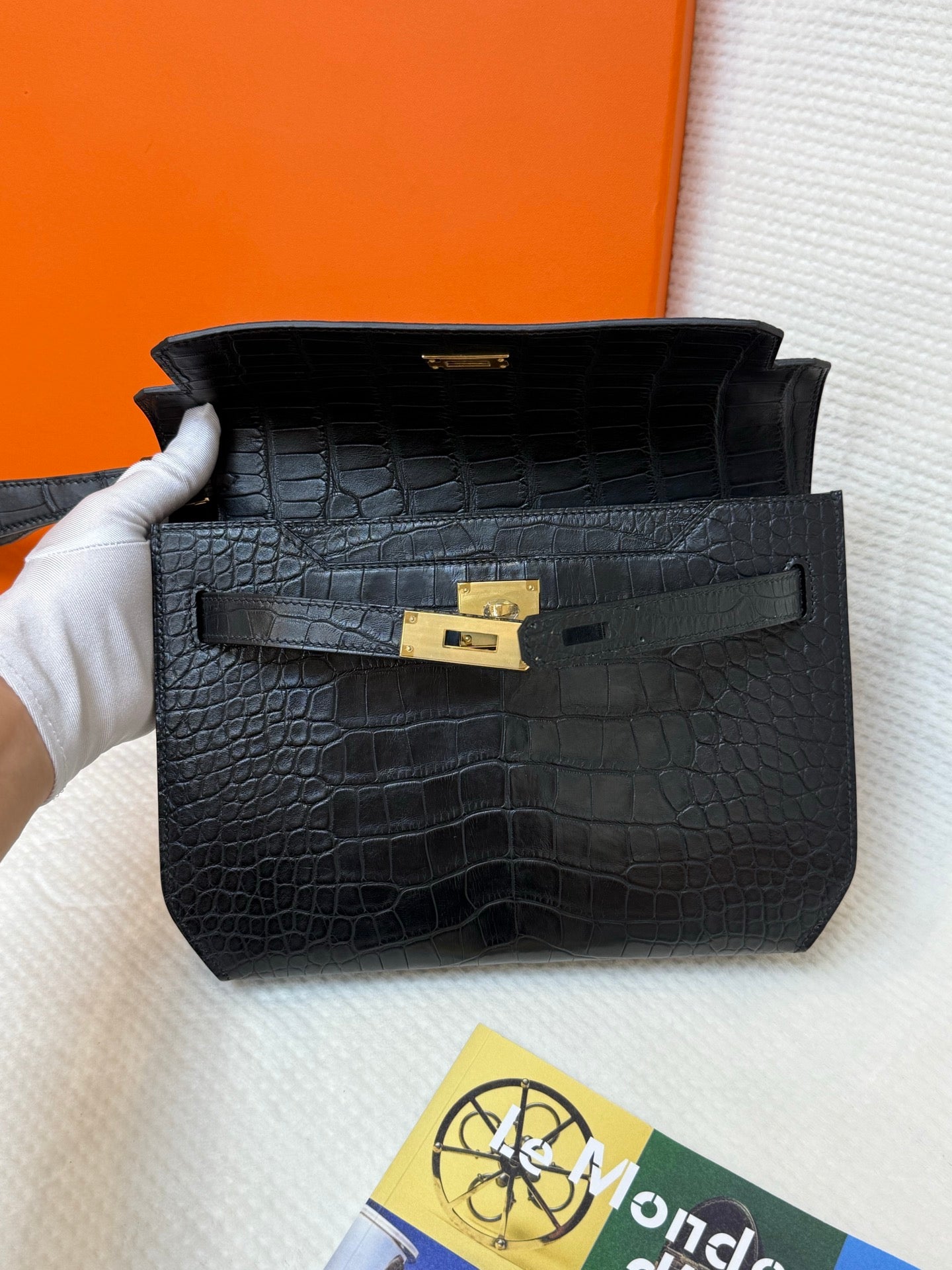 Hermes bag in black croc-embossed leather with gold clasp and front flap