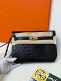 Hermes croc-embossed flap bag in dark navy with gold turn-lock and shoulder strap.