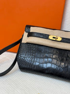 Hermes croc-embossed flap bag with beige lining band, gold clasp, and crossbody strap.