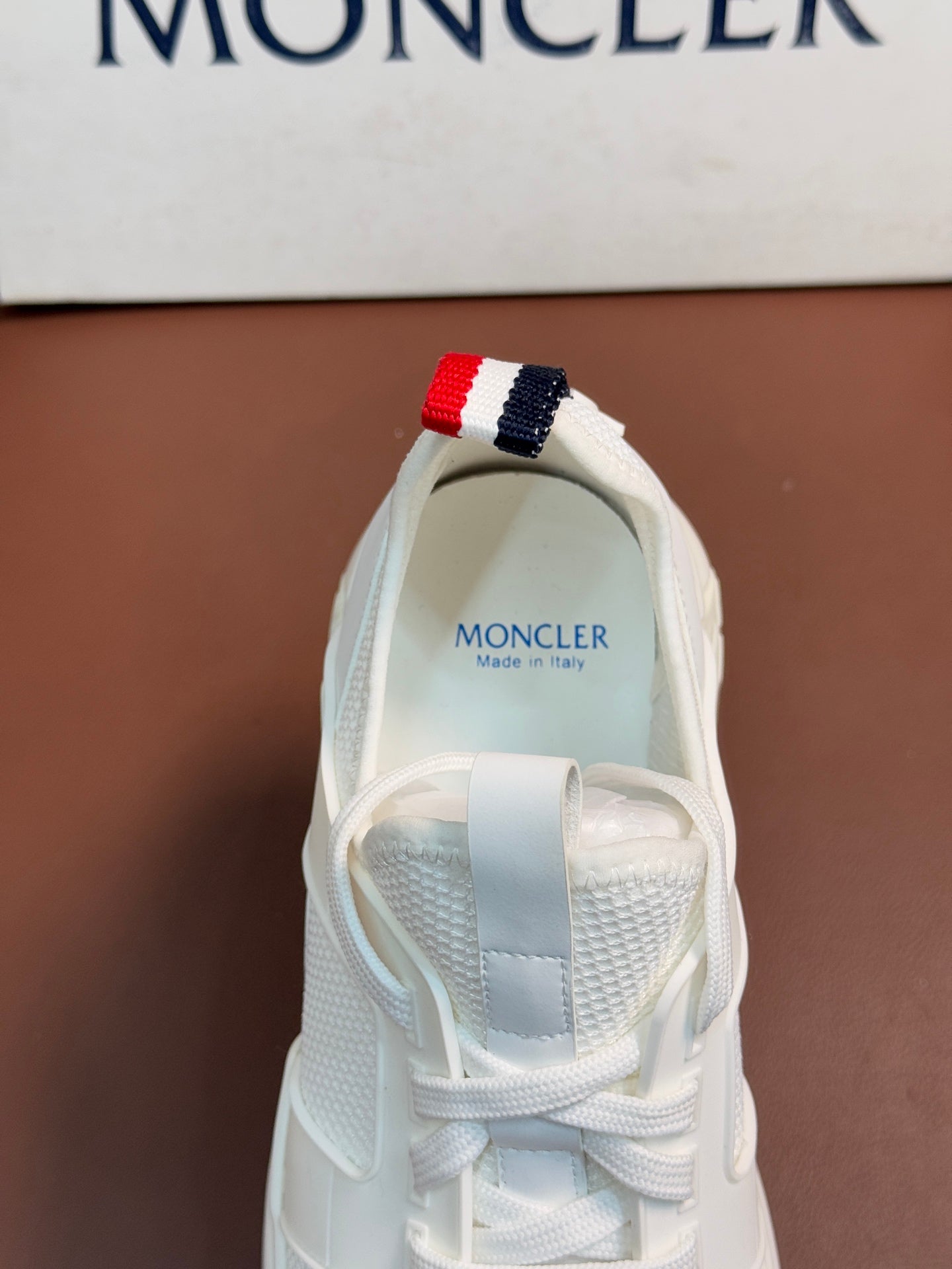 Moncler white sneaker heel with red and navy striped pull tab