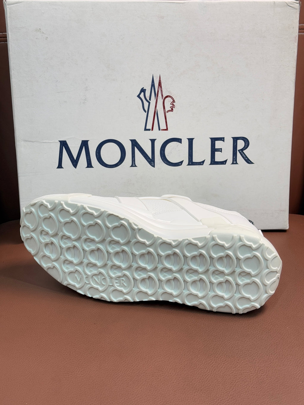 Moncler white sneaker outsole with textured tread and oval pattern