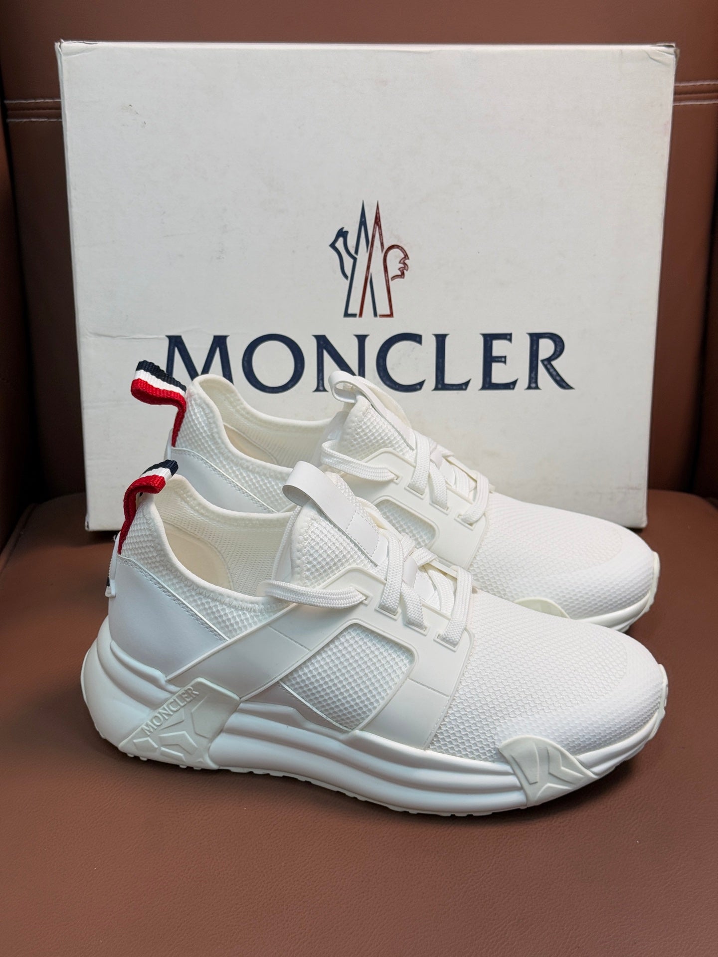 Moncler white sneakers with red and navy striped heel detail and padded sole