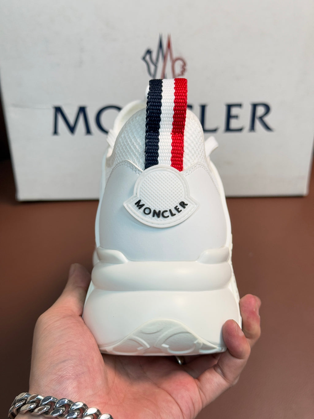 Moncler white sneaker heel, rear view, striped pull tab and logo on back