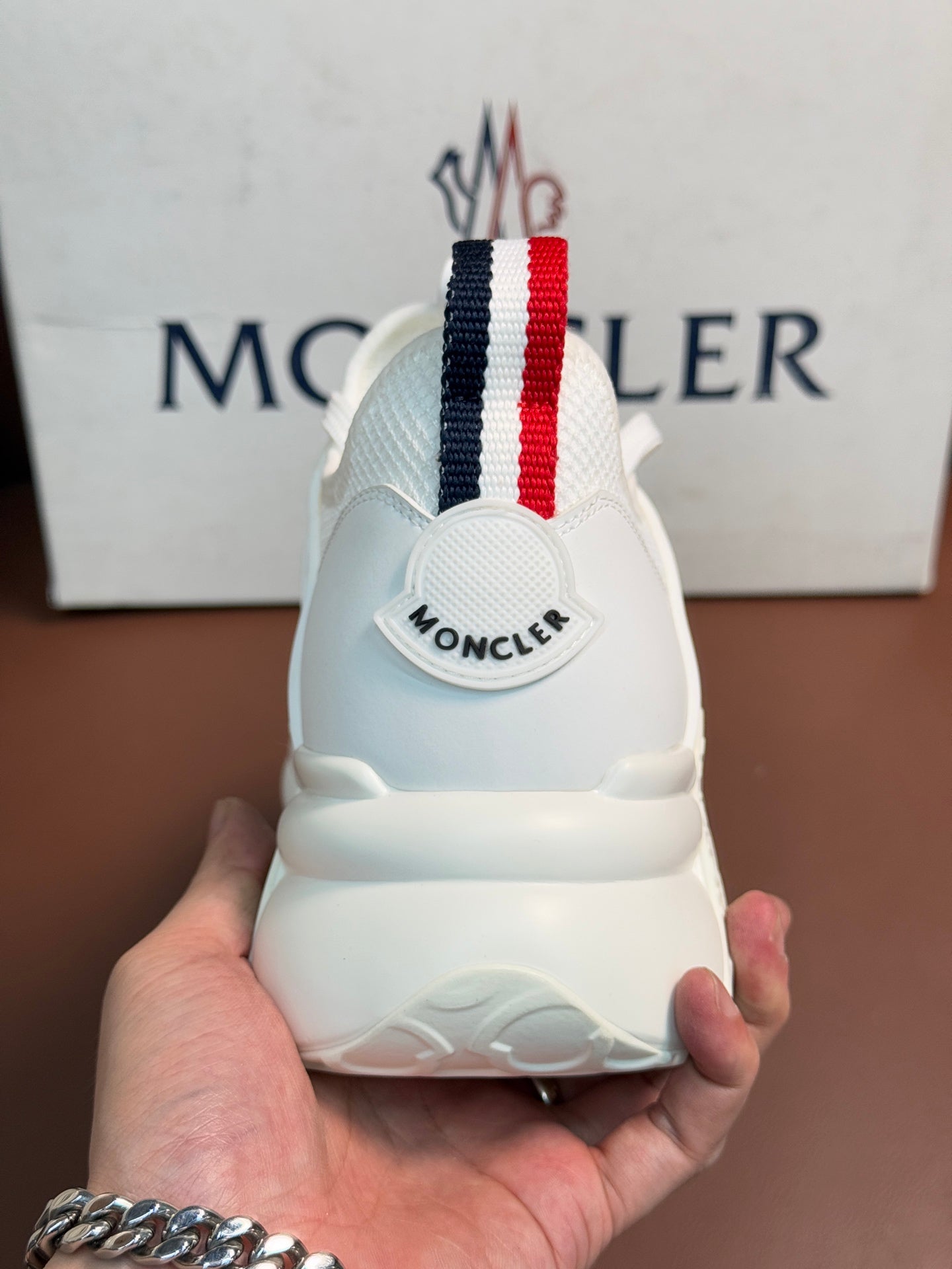 Moncler white sneaker heel, rear view, striped pull tab and logo on back