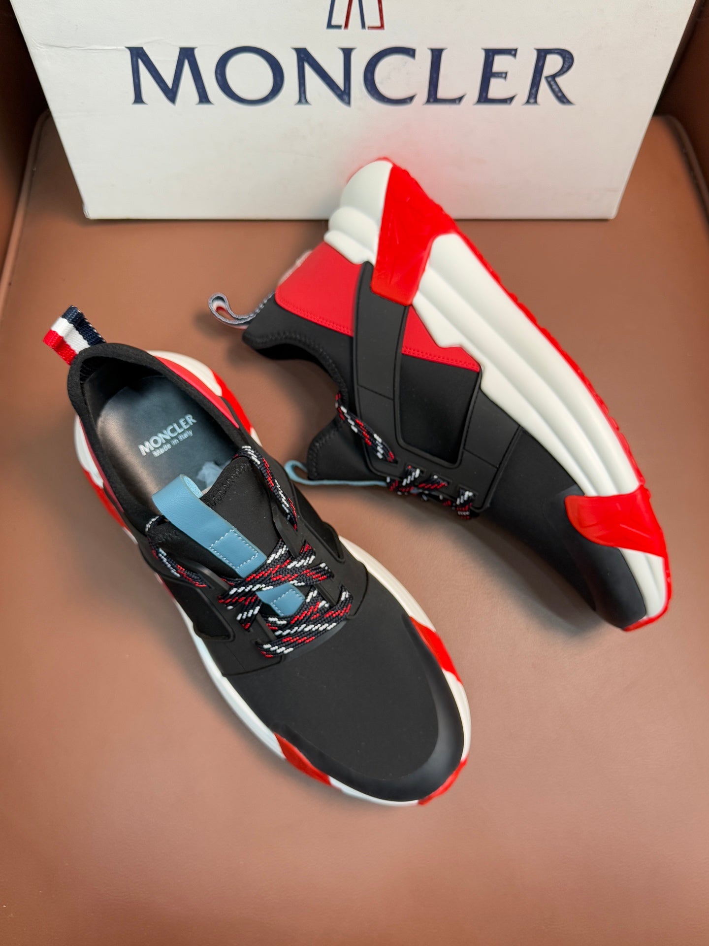 Moncler luxury shoes, black mesh upper with red and light blue panel accents